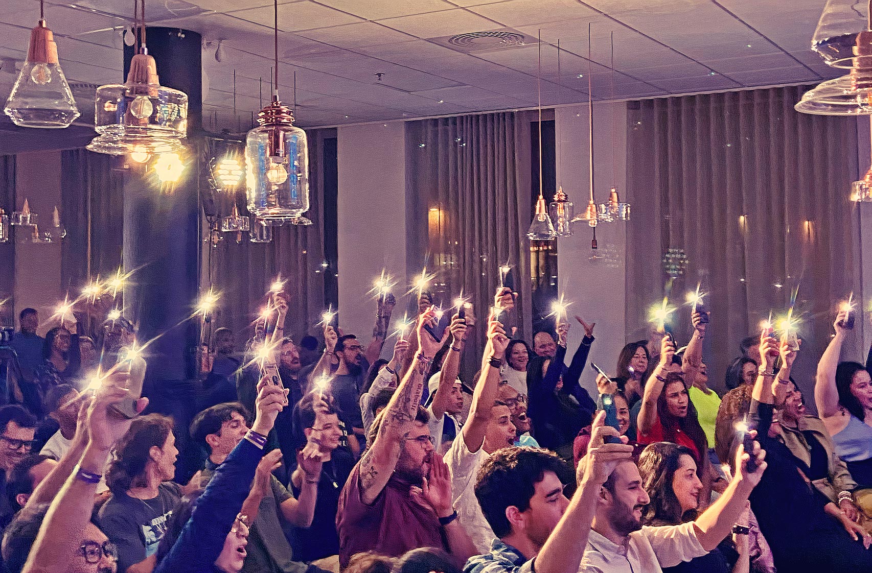 Audience with phone lights at the standup