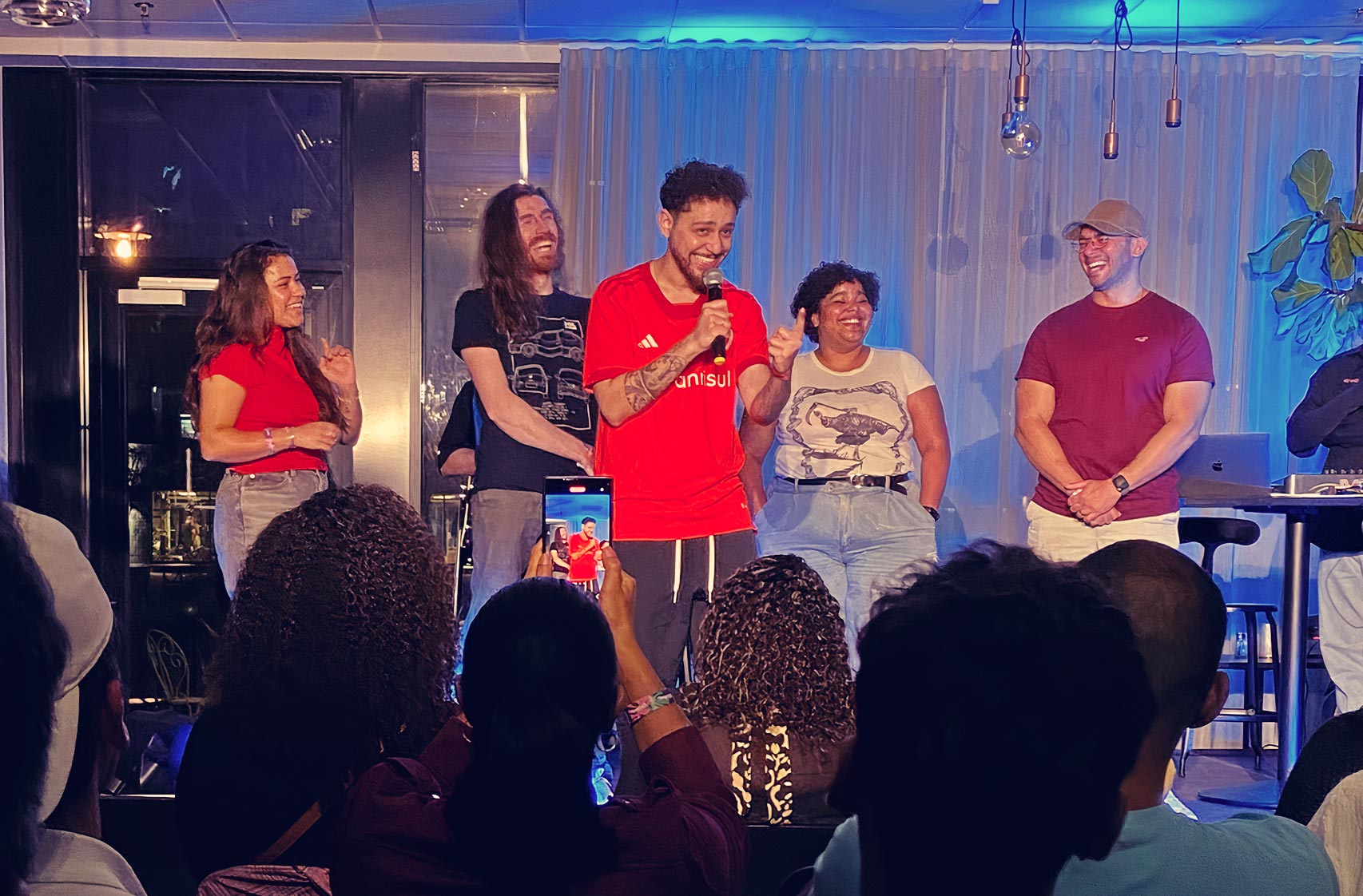 Comedian on stage with guests